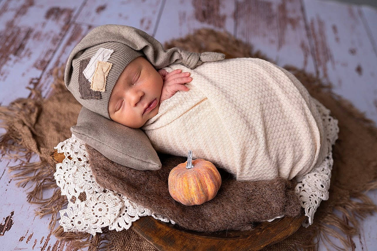 Micah is registered to the contest to win money with this photo: baby, baby_sleeping, baby_toddler_clothing, cap, child, comfort, eye, face, grass, happy, headgear, headwear, knit_cap, linens, people_in_nature, person, textile, toddler, tree, wood
