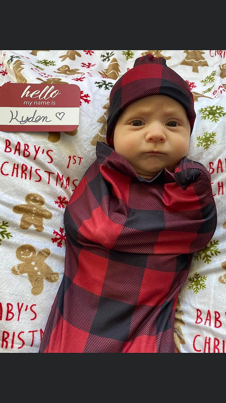 Kyden is registered to the contest to win money with this photo: cap, christmas, christmas_decoration, christmas_eve, comfort_food, event, happy, headwear, holiday, hoodie, ingredient, jacket, knit_cap, pattern, person, plaid, red, sleeve, tartan, toddler