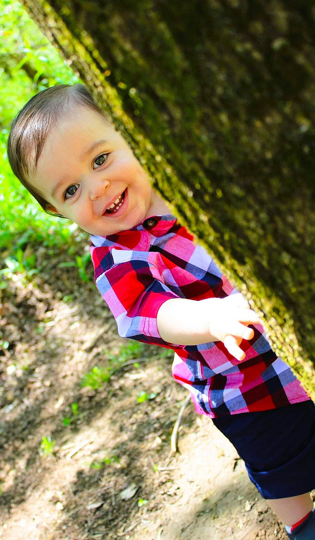 Darren is registered to the contest to win money with this photo: child, electric_blue, forest, fun, grass, happy, joy, landscape, laugh, leisure, pattern, people_in_nature, person, plaid, plant, recreation, sitting, smile, soil, t_shirt