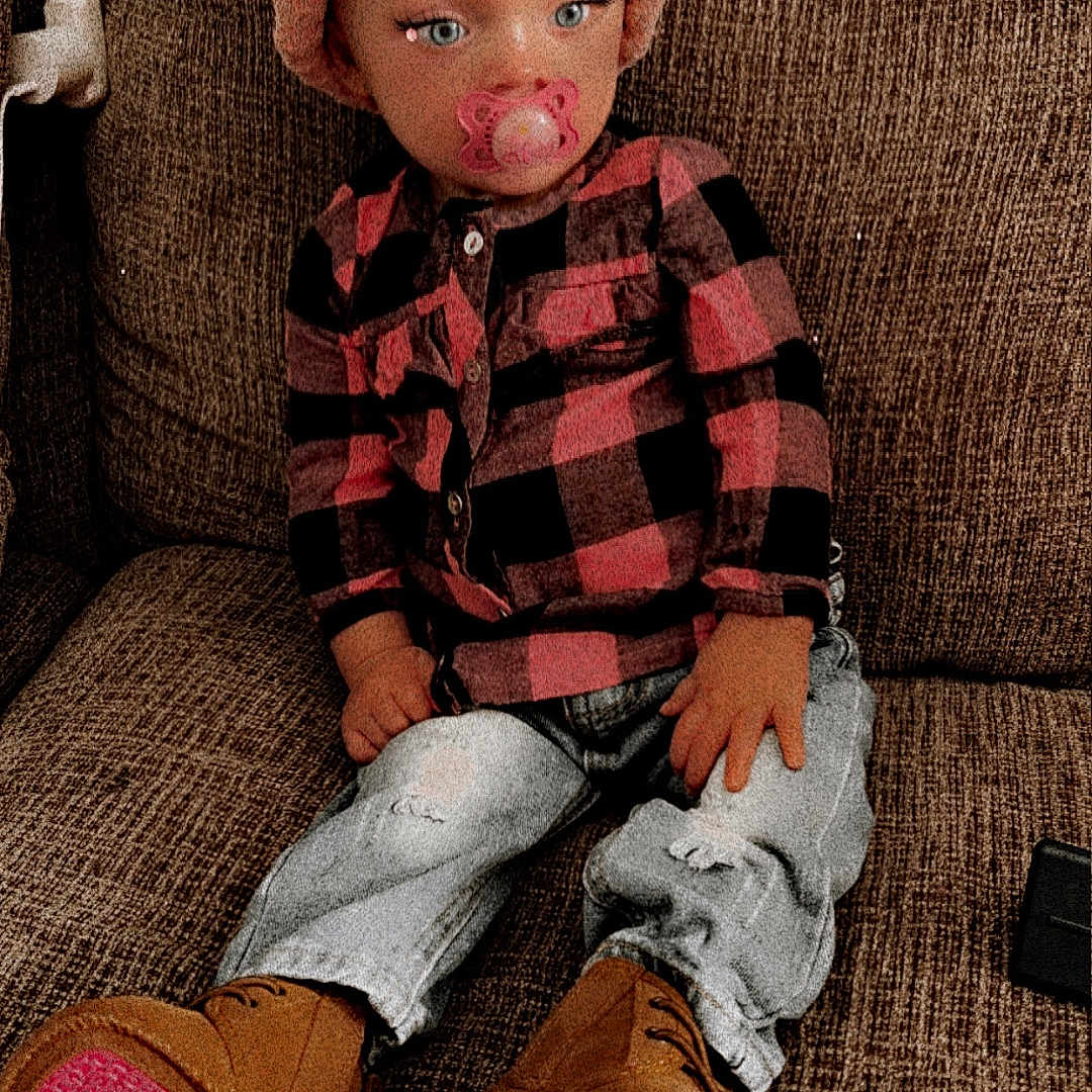 Kennedy is registered to the contest to win money with this photo: armchair, baby, cap, chair, clothing, couch, doll, face, footwear, furniture, hat, head, jeans, pants, person, photography, portrait, shoe, sitting, toy