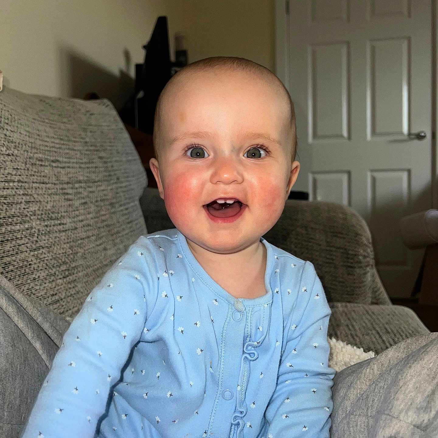 Aurora is registered to the contest to win money with this photo: architecture, baby, babylaughing, building, couch, cushion, face, furniture, happy, head, homedecor, indoors, laughing, livingroom, person, photography, portrait, room, sitting, smile