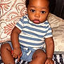 Camryn joined the competition — help win amazing prizes! baby, child, infant, striped_shirt, blue_shorts, curly_hair, big_eyes, sitting, bed, pillow, patterned_bedspread, indoor, cute, portrait, skin, foot, hand, young, person, casual_clothing