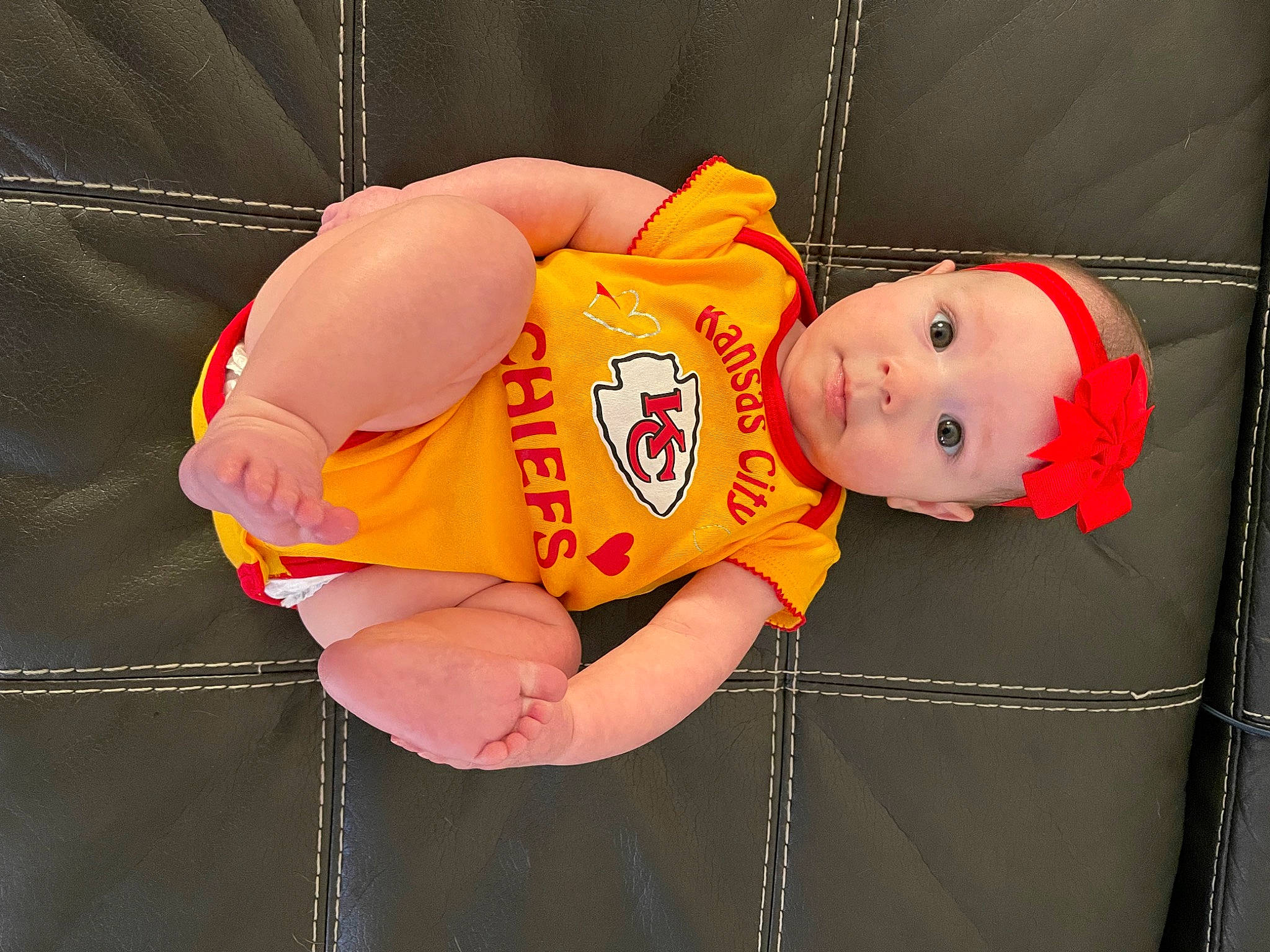 Remington is registered to the contest to win money with this photo: baby, baby_products, baby_toddler_clothing, child, costume, elbow, event, fun, happy, hat, headwear, human_body, orange, person, sleeve, smile, t_shirt, thumb, toddler, wrist