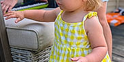 Ridlee Renee joined the competition — help win amazing prizes! toddler, child, yellow_dress, gingham_pattern, lemon_patch, wicker_chair, outdoor, wooden_deck, person, keyboard, blonde_hair, pigtails, curious, exploration, summer, casual_clothing, daylight, playing_music, hand, portrait