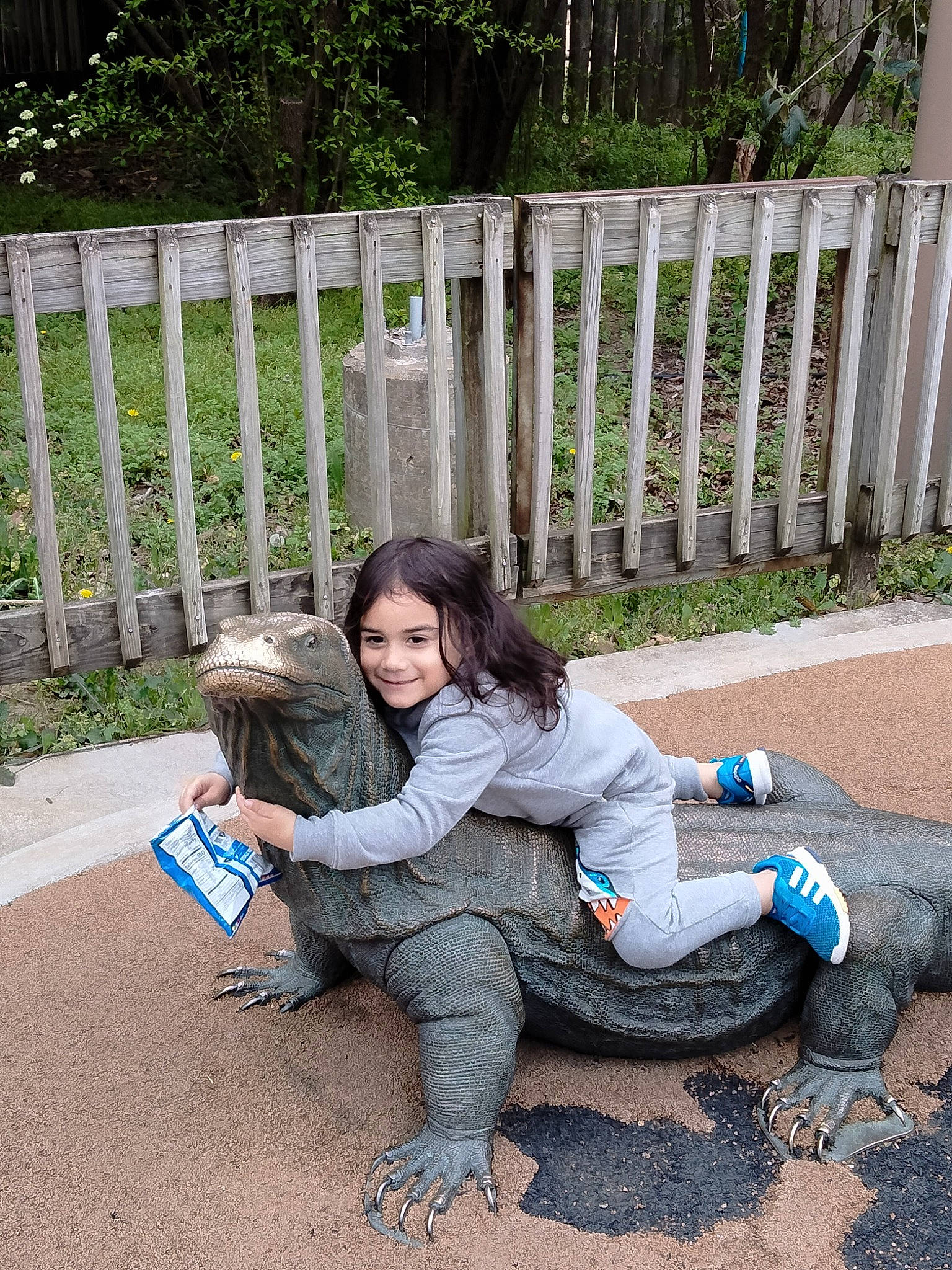 Jonathon Jr is registered to the contest to win money with this photo: child, denim, fence, fun, garden, grass, hairstyle, happy, joy, lawn, leg, leisure, luggage_and_bags, mammal, person, plant, recreation, shoe, sitting, sneakers