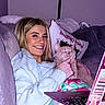 Tweaker is registered to the contest to win money with this photo: woman, cat, smiling, couch, blanket, laptop, indoor, cozy, christmas_pillow, lamp, blonde_hair, happy, pet, relaxing, sweater, home, technology, portrait, feline, holiday