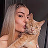 Tweaker joined the competition — help win amazing prizes! woman, cat, blonde_hair, kiss, affection, pet, indoor, bracelet, leopard_print, long_hair, close_up, portrait, feline, orange_cat, facial_expression, holding, cute, domestic_animal, love, person