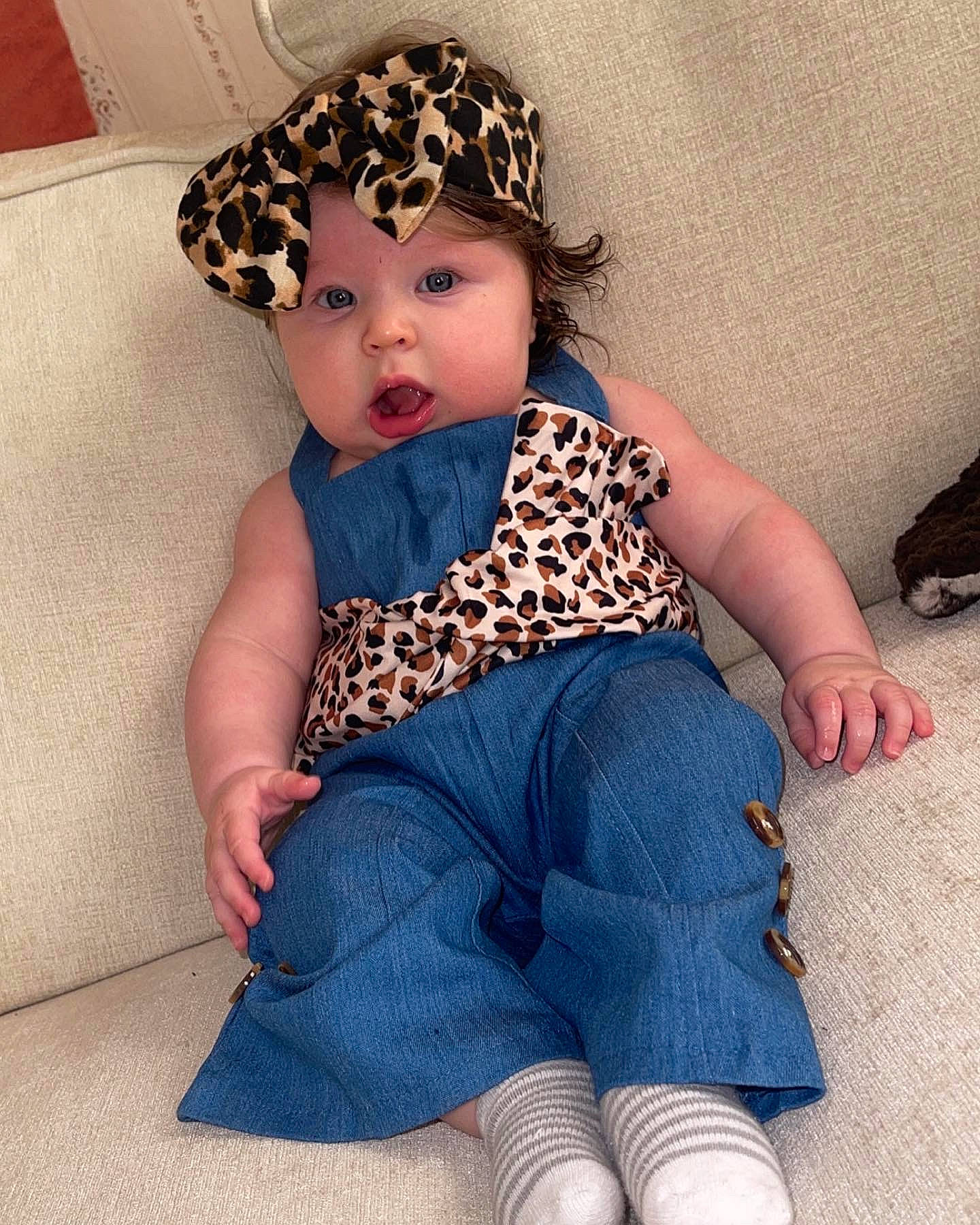 Brystol is registered to the contest to win money with this photo: baby, baby_toddler_clothing, barefoot, beauty, cap, child, costume_hat, electric_blue, face, fashion_accessory, foot, headwear, human_leg, knee, pattern, person, sitting, skin, sleeve, sock