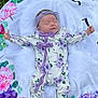 baby, blanket, colorful, cute, floral, flower_pattern, grass, headband, infant, lying_down, nature, newborn, onesie, outdoor, peaceful, person, portrait, purple_bows, sleeping, soft_texture