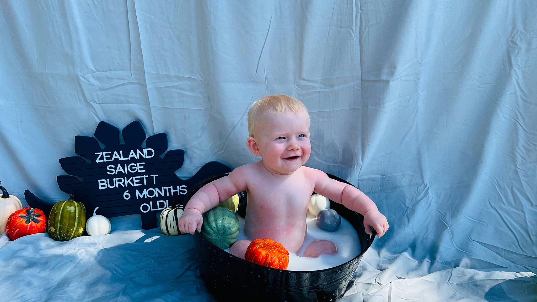 Zealand joined the competition — help win amazing prizes! baby, baby_products, baby_toddler_clothing, basket, bathing, child, curtain, flooring, fun, grass, happy, joy, leisure, natural_foods, person, play, recreation, sitting, smile, sweetness