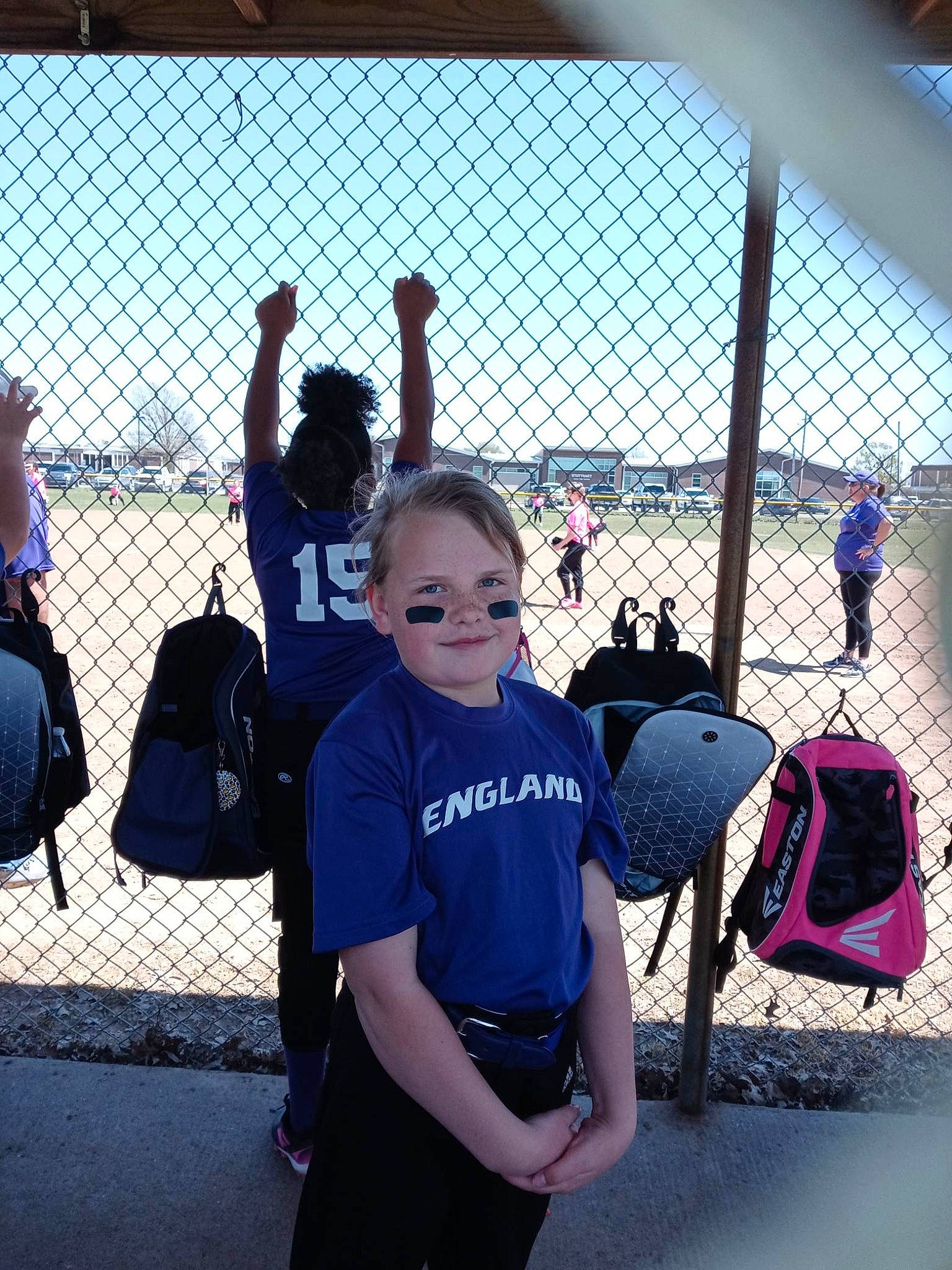 Samantha Skaggs is registered to the contest to win money with this photo: backpack, bag, black, city, crowd, fence, fun, gesture, handbag, joy, leisure, luggage_and_bags, metal, passenger, person, recreation, shorts, sky, t_shirt, team