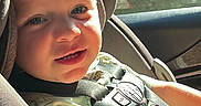 Greyson joined the competition — help win amazing prizes! child, toddler, car_seat, harness, sunlight, smile, face, blue_eyes, clothing, seatbelt, car_interior, window, daylight, skin, hair, person, vehicle, cute, sitting, baby