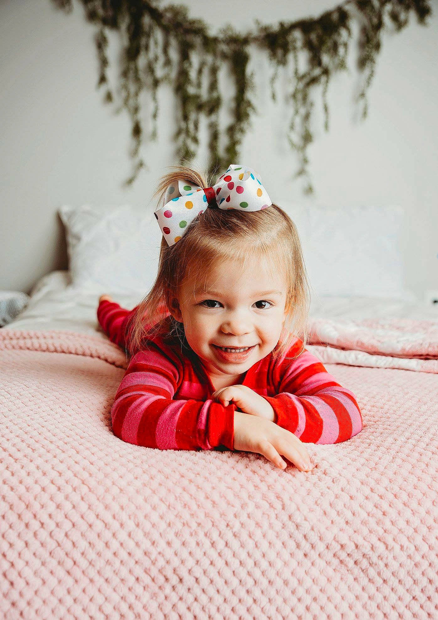 Collins is registered to the contest to win money with this photo: child, girl, hair_accessory, headpiece, infant, joy, person, red, skin, toddler