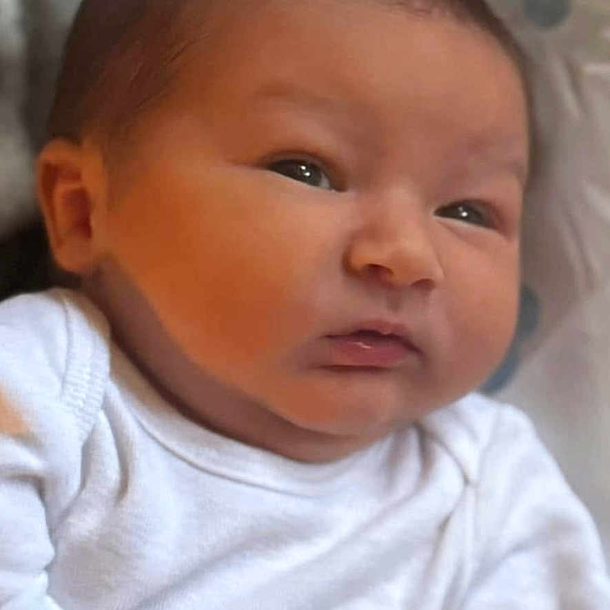 Isaiah is registered to the contest to win money with this photo: baby, cushion, face, frown, happy, head, homedecor, newborn, person, photography, portrait, sad, smile