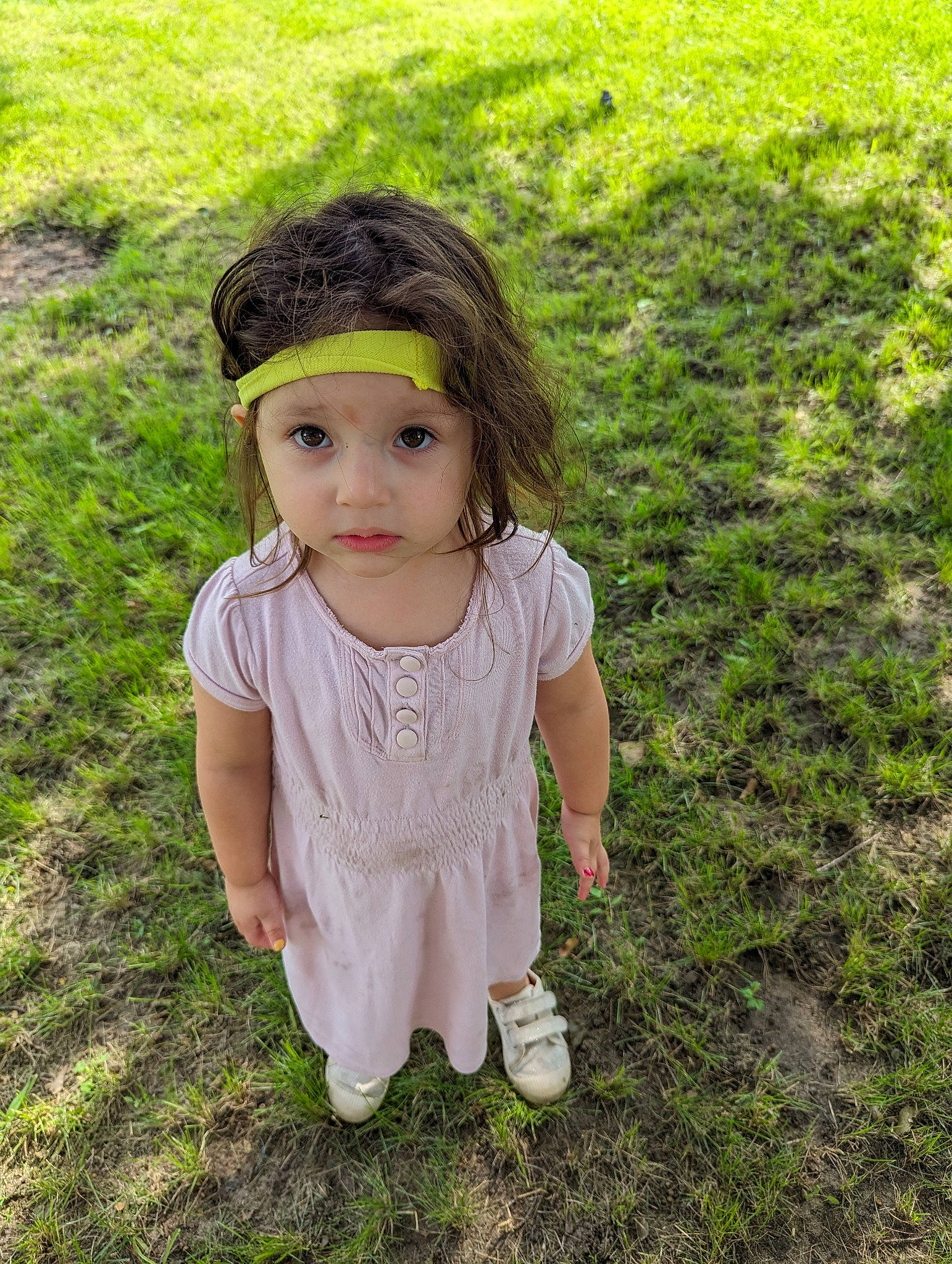 Katianna is registered to the contest to win money with this photo: baby_toddler_clothing, cap, child, facial_expression, fashion_accessory, fun, grass, grass_family, grassland, happy, headwear, leaf, outerwear, pattern, people_in_nature, person, sitting, skin, sleeve, t_shirt