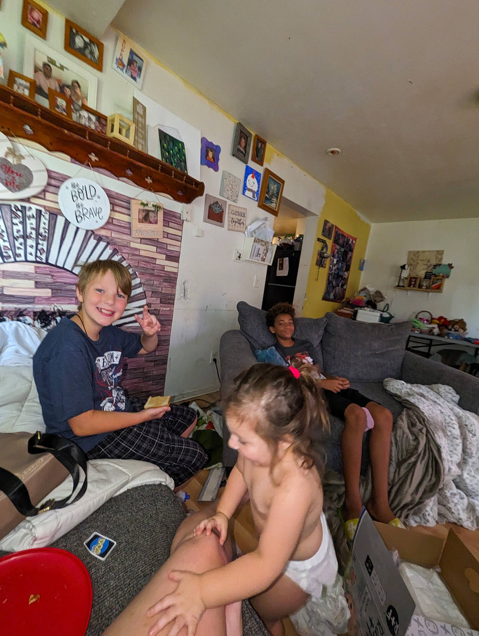 Dominic is registered to the contest to win money with this photo: comfort, couch, event, flooring, fun, hairstyle, human_leg, joy, lap, leisure, living_room, luggage_and_bags, party, person, picture_frame, room, shorts, sitting, t_shirt, television