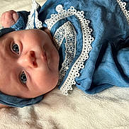 Brielle joined the competition — help win amazing prizes! baby, infant, blue_clothing, headband, lace, close_up, portrait, soft_texture, blanket, sleepwear, cute, child, newborn, resting, indoors, face, expression, peaceful, adorable, human