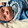 baby, infant, blue_clothing, headband, lace, close_up, portrait, soft_texture, blanket, sleepwear, cute, child, newborn, resting, indoors, face, expression, peaceful, adorable, human