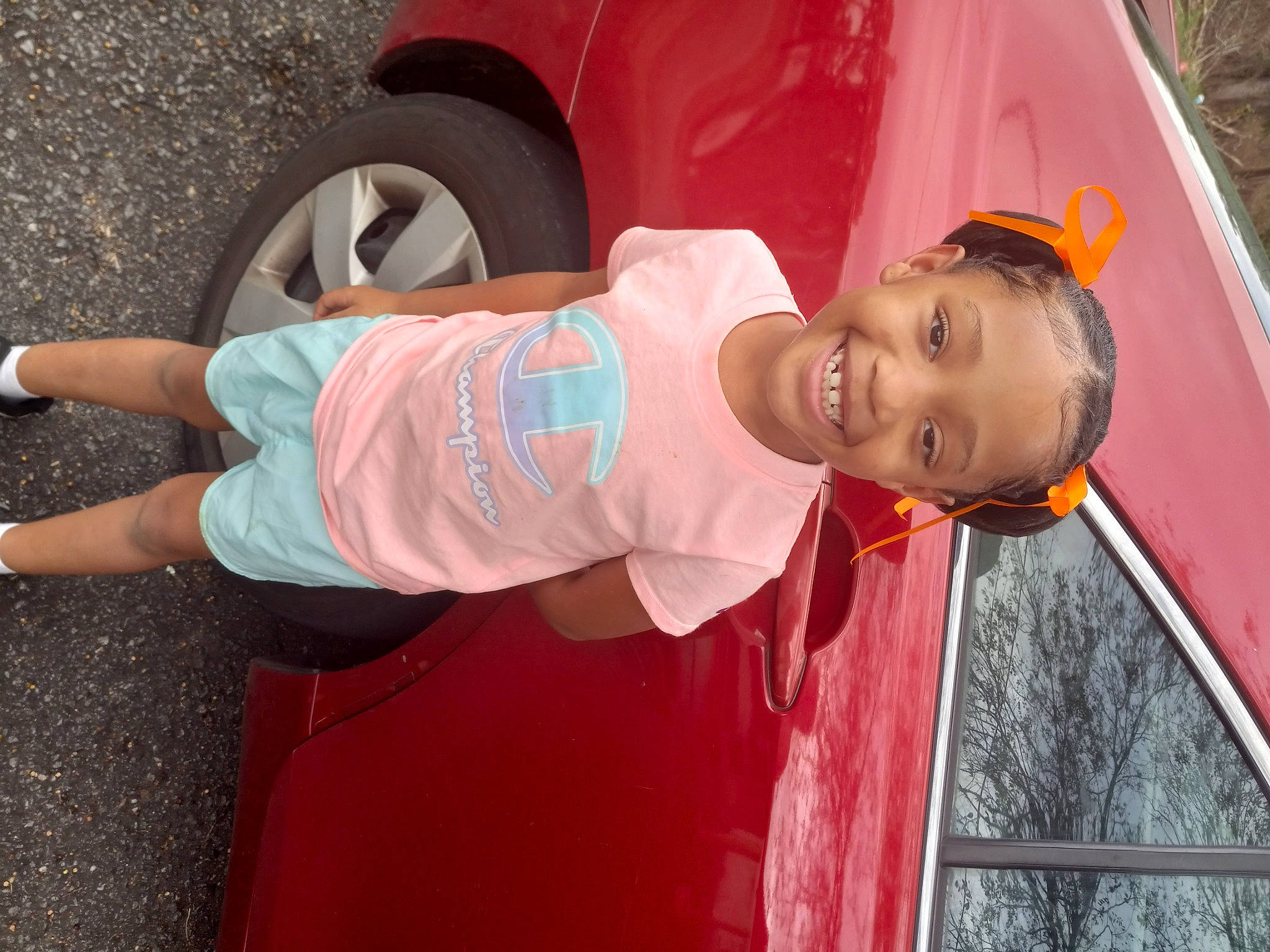 Tiana is registered to the contest to win money with this photo: automotive_exterior, automotive_lighting, automotive_tire, car, child, fun, happy, hat, joy, magenta, motor_vehicle, person, pink, red, shorts, smile, t_shirt, tire, toddler, vehicle