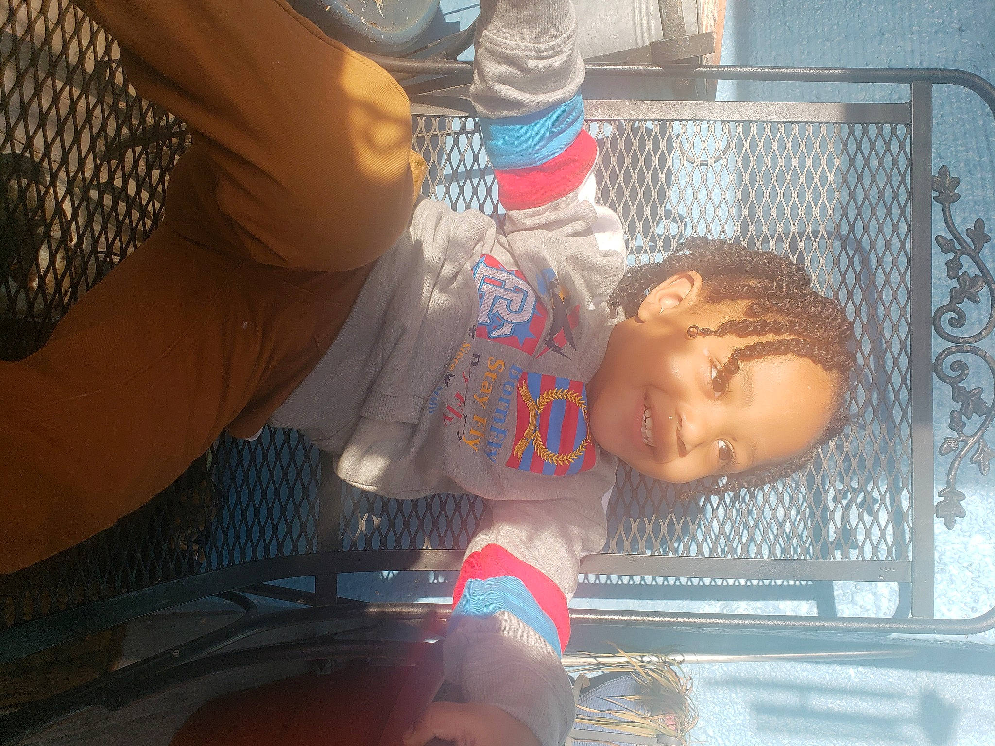 Paul is registered to the contest to win money with this photo: auto_part, automotive_lighting, bumper, child, cool, eyewear, fence, fun, happy, joy, leisure, mouth, person, sitting, toddler, tree, vehicle_door