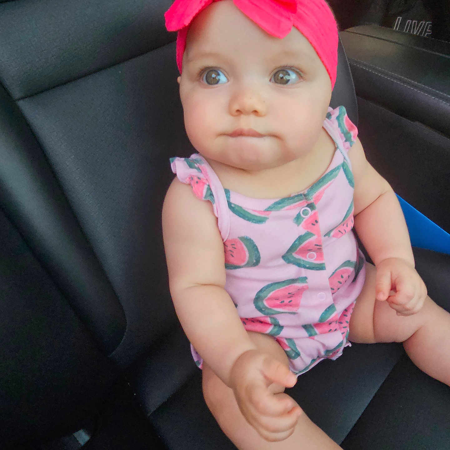 Ayleen joined the competition — help win amazing prizes! arms, baby, bow, car_seat, child, curious, cute, face, headband, indoors, infant, legs, person, pink, portrait, romper, sitting, skin, vehicle_interior, watermelon_print