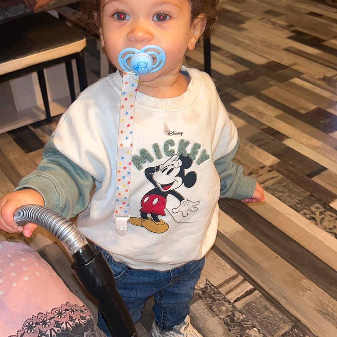 Paolo Greco participe au concours pour gagner de l'argent avec cette photo : blue_jeans, child, curly_hair, dog, face, flooring, furniture, hand, home, indoor, jacket, mickey_mouse, pacifier, patterned_floor, person, sweatshirt, toddler, toy, vacuum_cleaner, white_sneakers