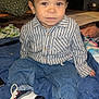 toddler, child, striped_shirt, jeans, sneakers, blue_blanket, indoor, hair, face, eyes, hands, footwear, clothing, sitting, floor, room, casual, young_child, portrait, baby