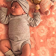 Cattaleya is registered to the contest to win money with this photo: baby, sleeping, infant, blanket, plush_toy, teddy_bear, pink, gray_clothing, headband, socks, soft_texture, cute, peaceful, lying_down, child, cozy, patterned_blanket, small_hands, adorable, indoor