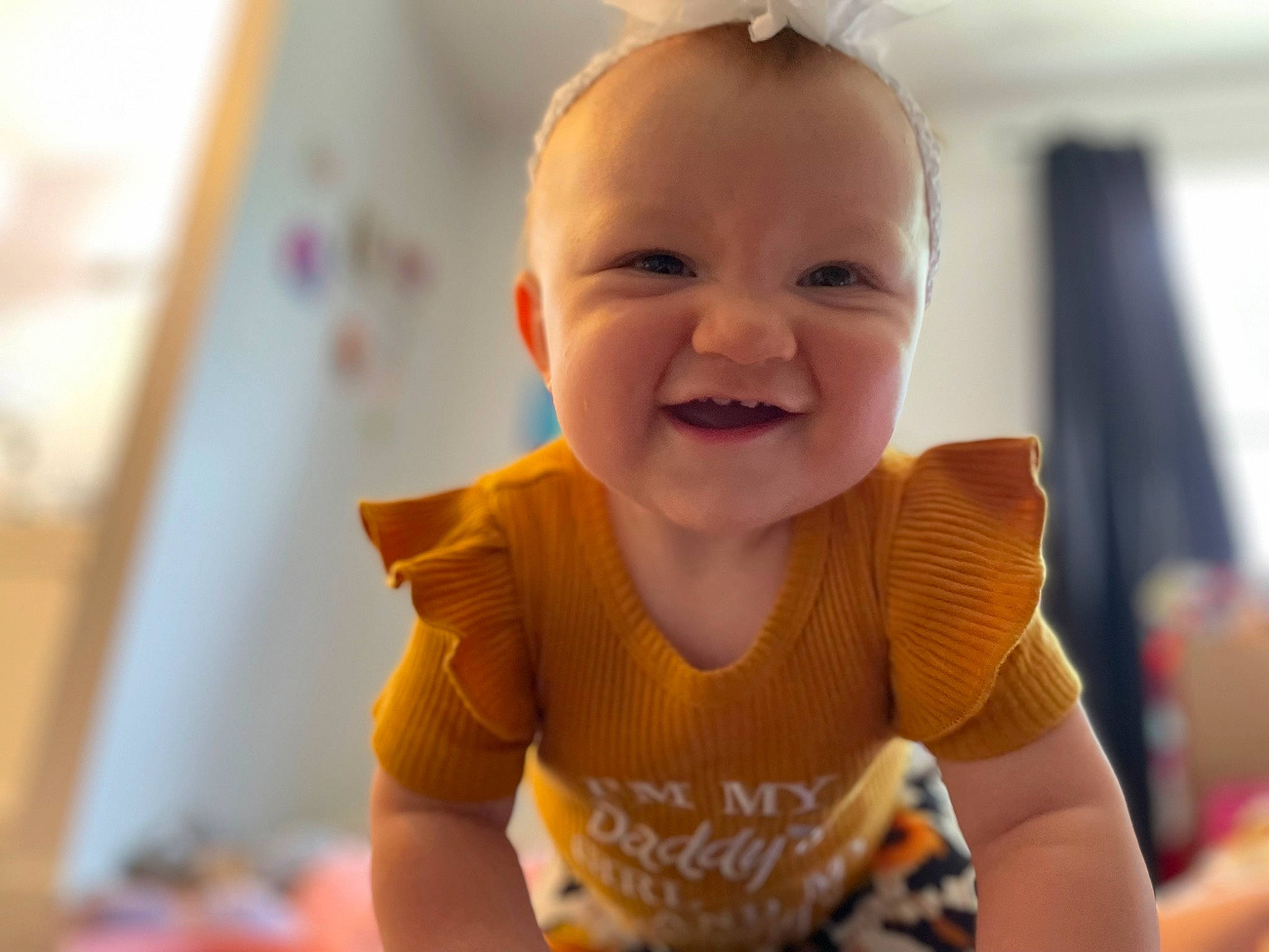 Winona is registered to the contest to win money with this photo: baby, baby_products, baby_toddler_clothing, cheek, child, fun, happy, iris, joy, laugh, lip, magenta, nose, person, room, sitting, skin, sleeve, smile, t_shirt