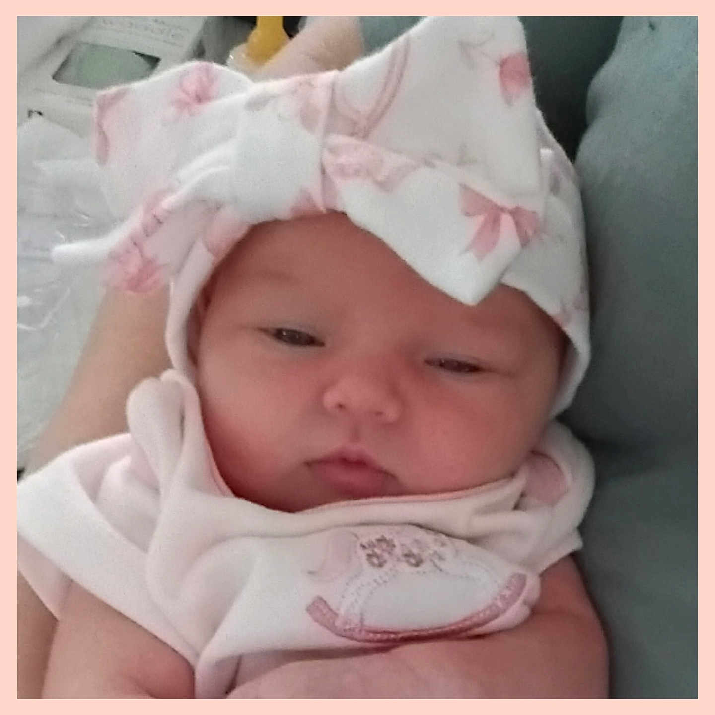 Danica Lynn is registered to the contest to win money with this photo: adorable, baby, blanket, bow, caregiver_arm, chubby_cheeks, close_up, cozy, fabric, face, hands, hat, headwear, infant, lying_down, newborn, pink_clothing, portrait, sleepy, soft_lighting