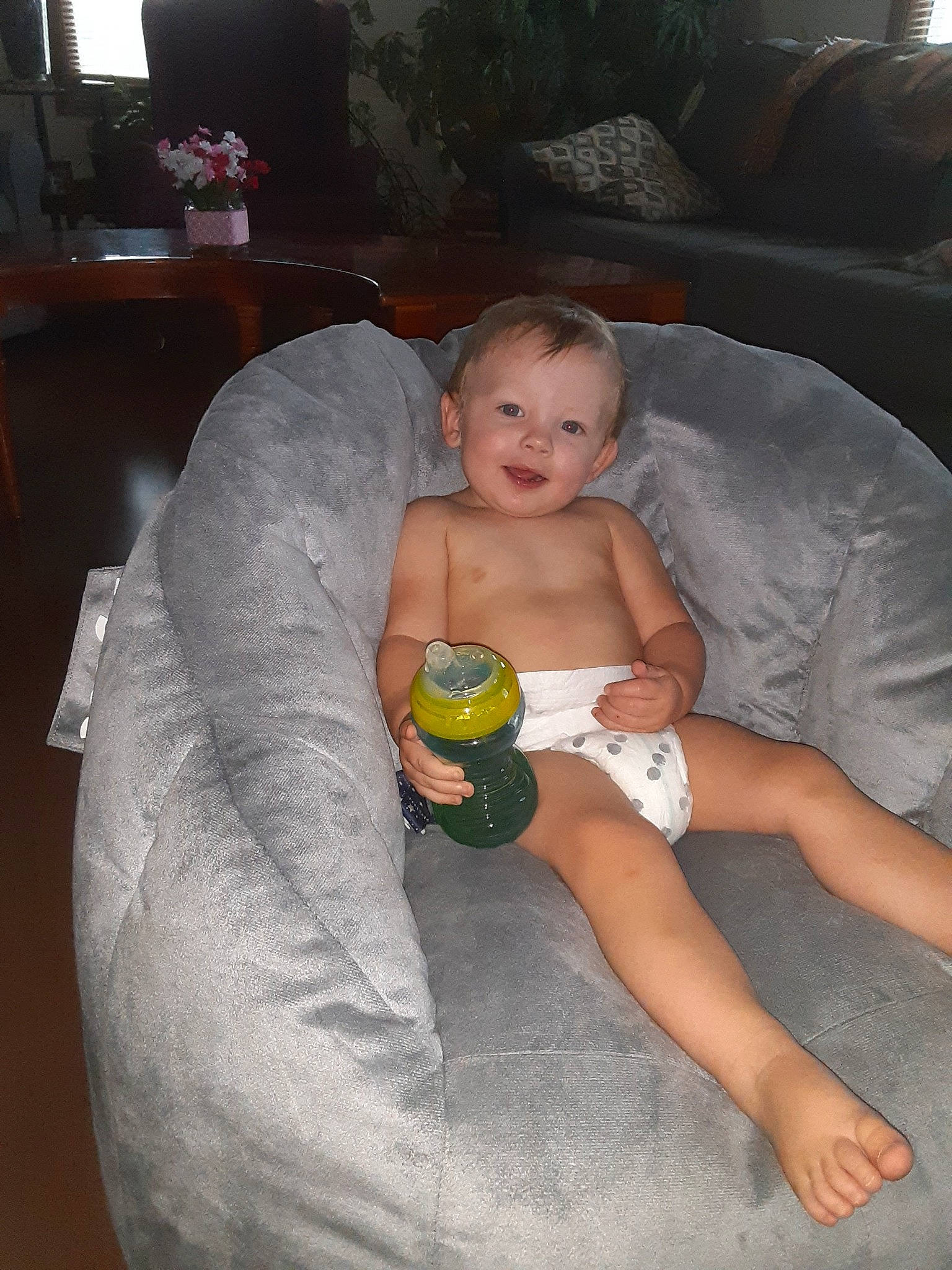 Paxton is registered to the contest to win money with this photo: abdomen, baby, bottle, chest, child, comfort, diaper, finger, furniture, hairstyle, human_body, joy, knee, lap, mouth, person, skin, stomach, textile, thigh