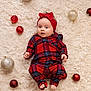 Izabela is registered to the contest to win money with this photo: baby, infant, plaid_clothing, headband, red, christmas_ornaments, gold_ornaments, fluffy_rug, holiday, cute, lying_down, indoors, festive, child, small_feet, soft_texture, decorations, portrait, one_person, holiday_theme