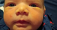 Scarlett joined the competition — help win amazing prizes! baby, face, close_up, infant, child, portrait, blue_clothing, ladybug_pattern, cute, young, skin, eyes, expression, head, newborn, person, childhood, soft_light, indoors, apparel