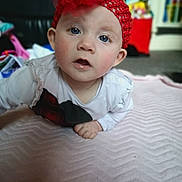 Bethany is registered to the contest to win money with this photo: baby, child, headband, red, blue_eyes, blanket, indoor, curious, face, person, soft_texture, clothing, long_sleeve, infant, focus, candid, closeup, expression, cute, toddler