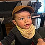 toddler, child, cap, bib, indoor, playpen, curious, face, clothing, person, couch, shirt, window, plaid, wood_floor, hand, expression, young_child, baby, home