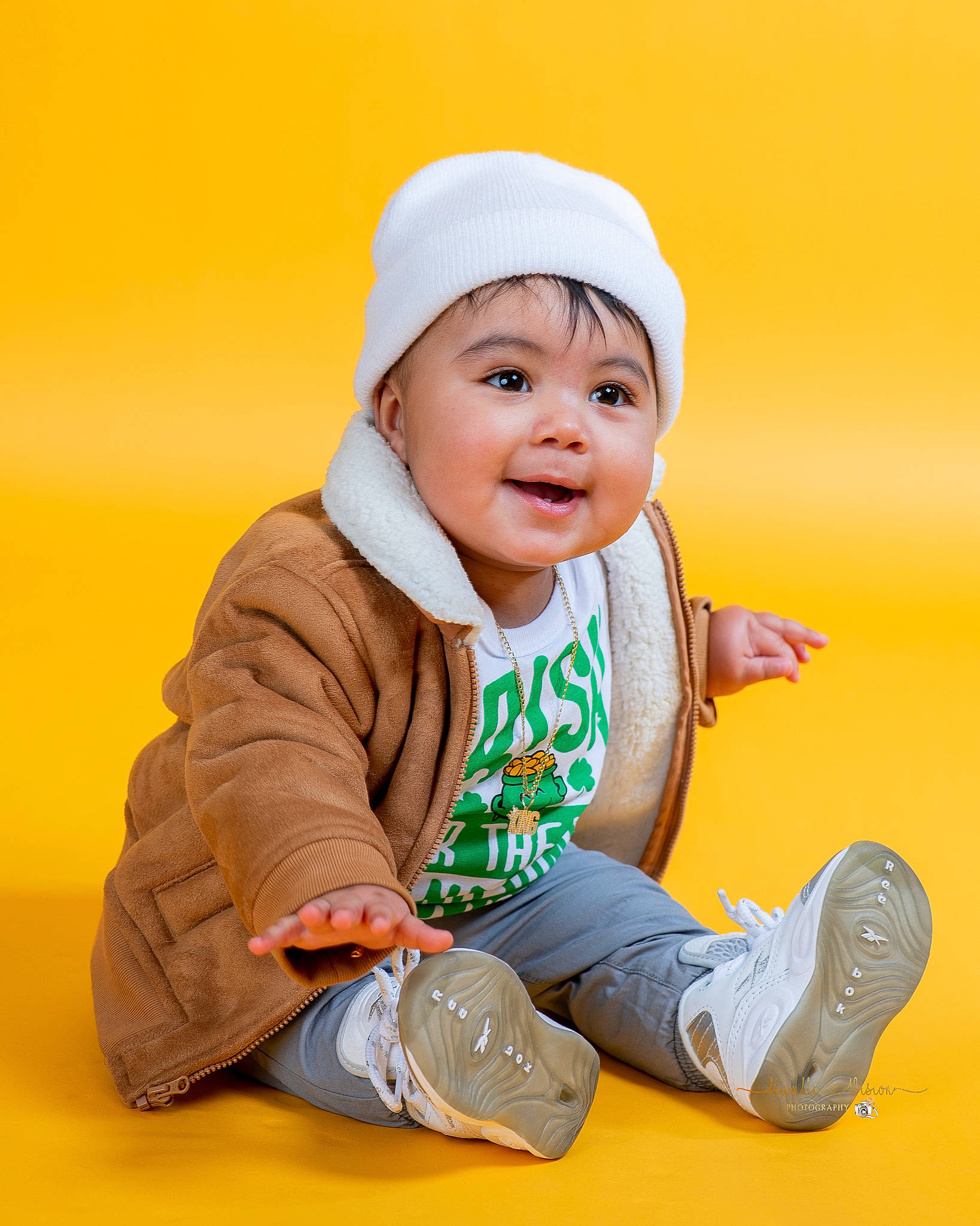 Izaiah joined the competition — help win amazing prizes! baby, baby_toddler_clothing, beanie, cap, cheek, child, comfort, eye, face, finger, flash_photography, flooring, fun, happy, headwear, orange, outerwear, person, sitting, sleeve