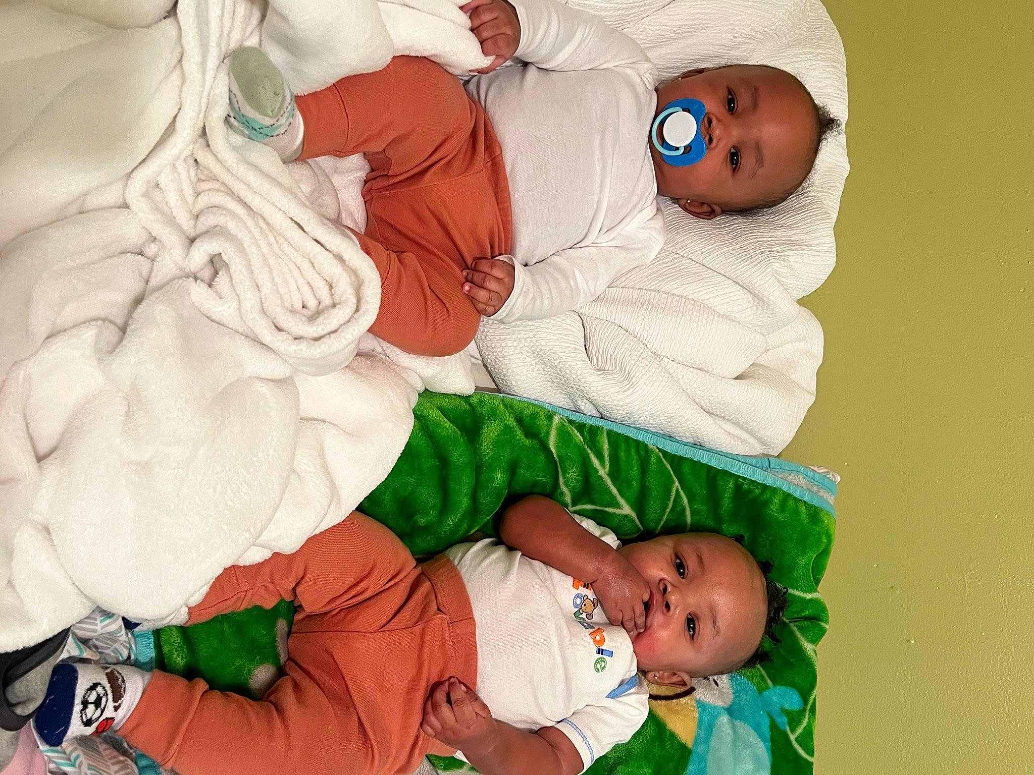 Jordan is registered to the contest to win money with this photo: baby, baby_products, baby_sleeping, baby_toddler_clothing, child, comfort, event, fictional_character, green, happy, hat, head, lap, linens, organ, person, room, sleeve, sock, toddler