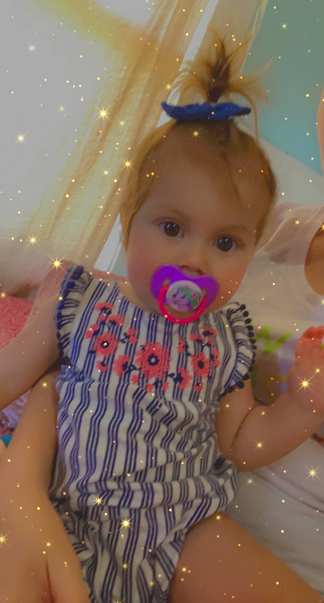 Ivanna is registered to the contest to win money with this photo: baby, baby_toddler_clothing, cheek, child, christmas, christmas_decoration, christmas_ornament, event, facial_expression, fun, happy, head, holiday, human, ornament, party_hat, party_supply, person, pink, purple