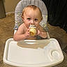 Jacob is registered to the contest to win money with this photo: toddler, child, high_chair, cupcake, whipped_cream, kitchen, tile_floor, curtains, food, messy_face, eating, person, indoor, young_child, happy, cute, sitting, snack, small_hands, light_brown_hair