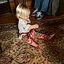 Kenzie is registered to the contest to win money with this photo: baby, child, christmas, dress, family, floor, flooring, fun, holiday, leg, people, play, room, sitting, toddler, vacation, wood
