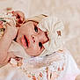 adorable, baby, blanket, bow, butterfly, child, closeup, cute, embroidered, eyes, face, flowers, hand, headband, infant, lying, mouth, portrait, skin, soft