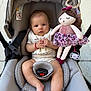 Isabella is registered to the contest to win money with this photo: baby, stroller, plush_doll, infant, child, seat_belt, gray, toy, pacifier, fabric, clothing, cute, hands, feet, sitting, indoor, soft_toy, person, young_child, expression