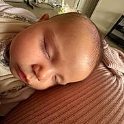 Isabella is registered to the contest to win money with this photo: baby, sleeping, face, head, blanket, ribbed_texture, indoor, home, furniture, iron, resting, peaceful, child, person, soft_light, skin, cozy, toddler, portrait, closeup