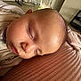 baby, sleeping, face, head, blanket, ribbed_texture, indoor, home, furniture, iron, resting, peaceful, child, person, soft_light, skin, cozy, toddler, portrait, closeup