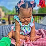 Alaina joined the competition — help win amazing prizes! baby, child, curly_hair, pink_bows, pink_blanket, outdoor, table, hand, flower, summer_clothing, green_sleeve, skin, cute, infant, sitting, nature, daylight, portrait, curious, soft_texture
