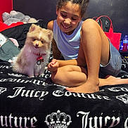 Milo joined the competition — help win amazing prizes! accessory, animal, bed, blanket, casual, child, clothing, cute, dog, furniture, girl, hair, happy, indoor, pet, portrait, relaxed, room, smiling, young