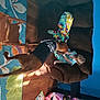 Elvis is registered to the contest to win money with this photo: art, artist, event, fawn, fun, hat, human_leg, leisure, linens, mural, organism, paint, painting, pattern, room, sunglasses, textile, tree, visual_arts