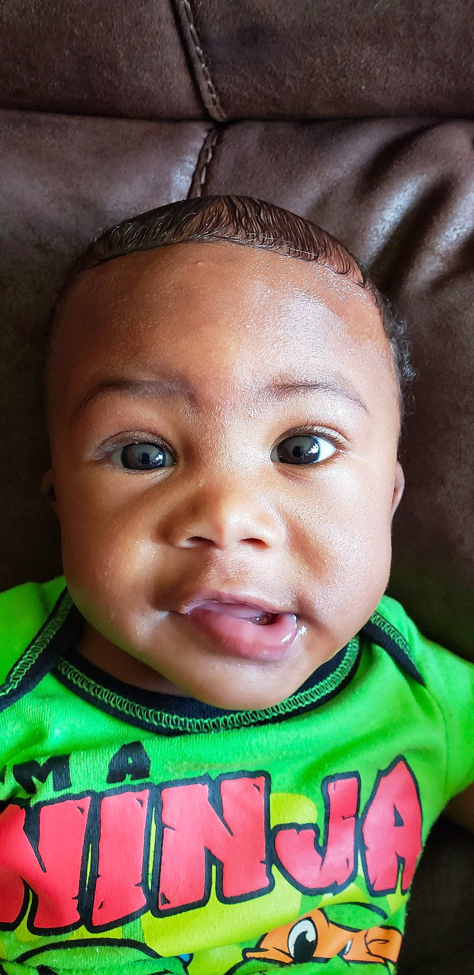 Quincy is registered to the contest to win money with this photo: boy, cheek, child, close_up, eye, eyebrow, face, forehead, green, head, human, infant, lip, mouth, nose, organ, person, skin, smile, toddler