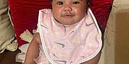 Kvori is registered to the contest to win money with this photo: baby, bib, bow, child, couch, cushions, cute, happy, headband, indoor, infant, leather, mittens, pink, portrait, sitting, smiling, tulle, tutu, white