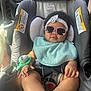 accessory, baby, bib, car_seat, child, clothing, cute, foot, hand, headband, indoor, infant, pacifier, portrait, relaxing, seatbelt, smiling, sunglasses, sunlight, vehicle